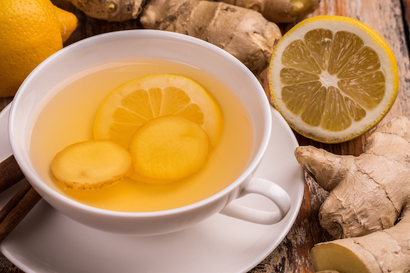 Ginger and lemon tea in white cup